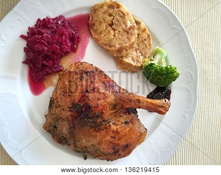 Austrian food, Roasted Duck with steamed bread dumplings called Serviettenknoedel and sweet sour red cabbage. Popular cuisine in Austria, Europe
