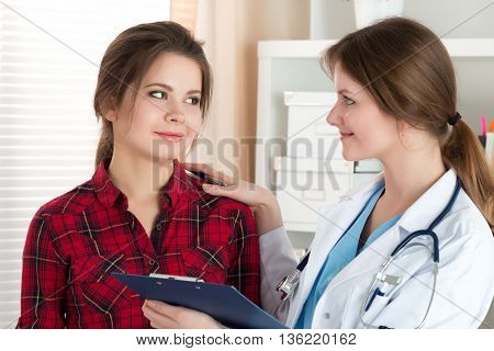 Friendly female doctor touching patient shoulder for encouragement empathy cheering and support after medical examination. Trust and ethics concept. Good news healthcare and medical service concept