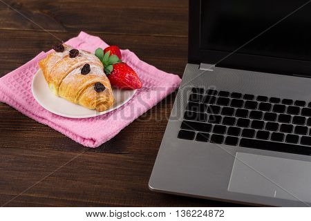 breakfast work with coffee and croissant. notebook