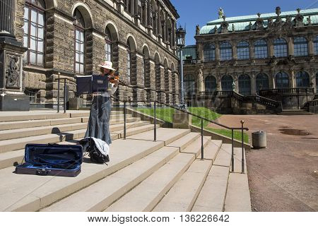 DRESDEN, GERMANY - JUNE 5, 2013:Violinist on the steps of the Dresden Art Gallery