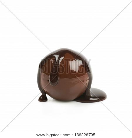 Chocolate ball candy coated with the hot liquid chocolate, composition isolated over the white background