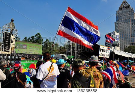 Bangkok Thailand - January 13 2014: Protestors listening to speeches at Lumphini Park carrying Thai flags at Operation Shut Down Bangkok *