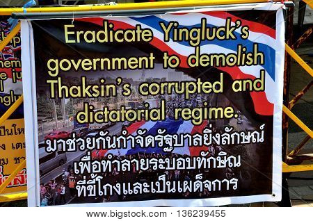 Bangkok Thailand - January 15 2014: Sign in English and Thai espouses bringing down the government of Yingluck Shiniwatra at Operation Shut Down Bangkok