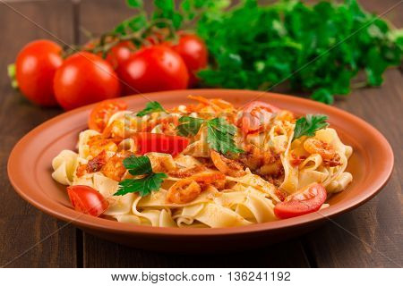 Fettuccine Pasta With Shrimp Tomatoes And Herbs. Wooden Background