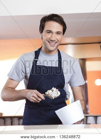 Waiter With Butterscotch Ice Cream And Cup At Parlor