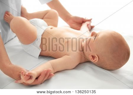 Doctor doing exercises with baby