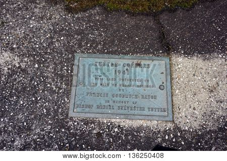 HARBOR SPRINGS, MICHIGAN / UNITED STATES - DECEMBER 24, 2015: A plaque the donation of the land at Tuttle Corners to the City of Harbor Springs, in memory of Bishop Daniel Sylvester Tuttle.