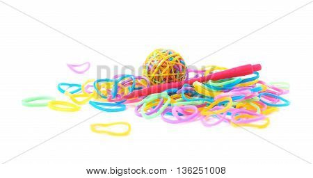 Pile of multiple colorful rubber toy loom bands isolated over the white background