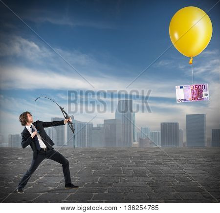 Businessman with arch pointed banknote attached to a balloon