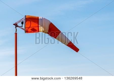 A wind indicator wind sock at an airport