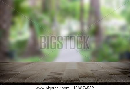 Selected focus empty brown wooden table and for product display montage big wooden table and garden.