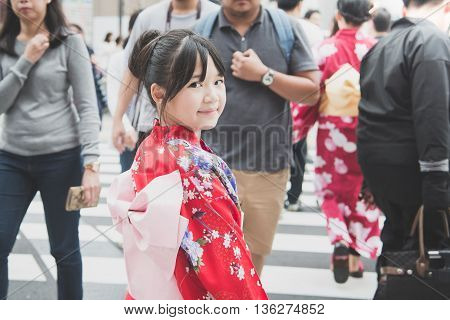 Beautiful Asian girl wearing red kimono walking in the cityAsakusa Tokyo Japan.