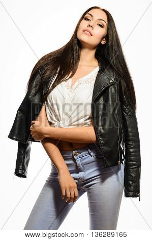 Glamorous young bautiful brunette woman in black leather jacket white T-shirt and jeans posing on a white background