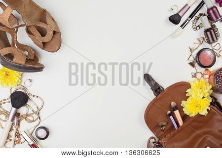 Women's accessories and cosmetics. Top view photo of colorful and glamour objects with free space for logo. There are shoes and perse