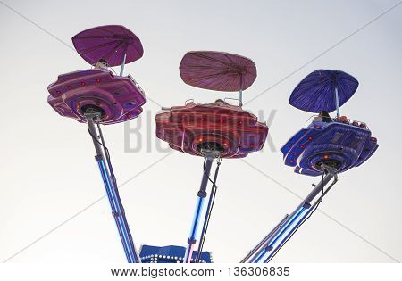 Vintage ship space funfair attraction at dusk Spain