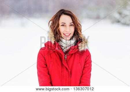 Girl in a red coat walks winter day