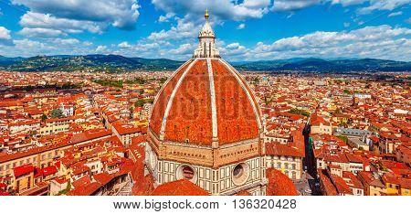 Panoramic view to dome of cathedral santa maria del fiore in florence and red tegular roofs old town clouds the sky