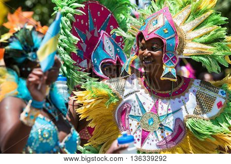 ATLANTA, GA - MAY 2016:  Women wearing elaborate feathered costumes walk in a parade to celebrate Caribbean culture along North Avenue in Atlanta GA on May 28 2016.