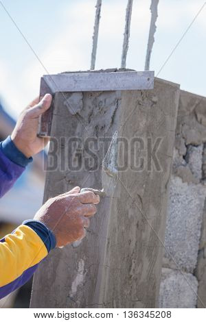 Worker Use Iron Ruler Snd Trowel Plastering The Poles