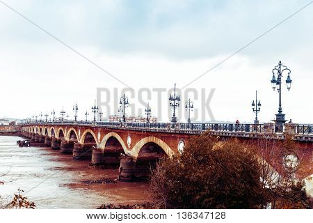 Old stony bridge in Bordeaux, France Europe