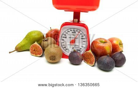 Fruit and kitchen scales isolated on white background. horizontal photo.
