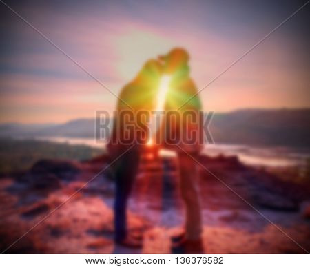 Abstract Blurred and soft photo of the lover standing on the hilltop during sunrise.