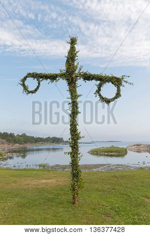 Tiny maypole the sea in the background. No people