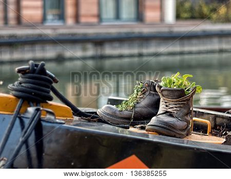 A pair of up-cycled boots on a narrowboat