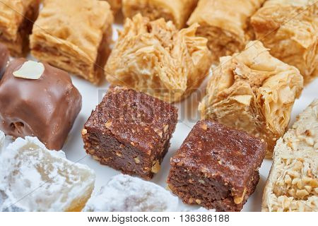 Oriental sweets on a white plate. Turkish or greek delight