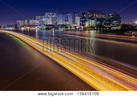 long exposure photography of siriraj hostipal and lighting of boat traffic in chaopraya river important landmark of bangkok thailand capital