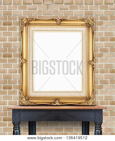 Blank Vintage Golden Photo Frame Lean At Pale Orange Brick Wall On Wood Table