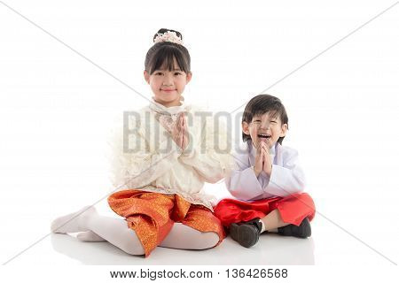 Asian children welcome expression Sawasdee on white backgroundisolated