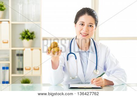 Young Asian Nutritionist Doctor Writing Diet Plan