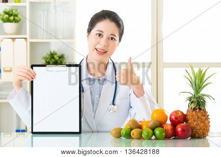 Doctor Nutritionist With Fruits Holding Blank Clipboard And Thumb Up