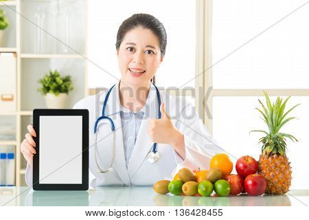 Doctor Nutritionist With Fruits Holding Blank Digital Tablet And Thumb Up