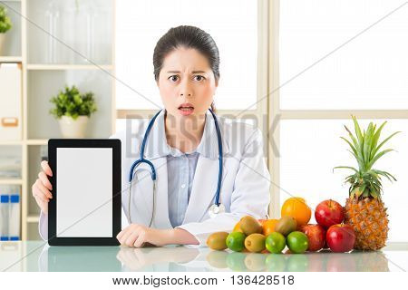 Doctor Nutritionist With Fruits And Holding Digital Tablet Fell Fear