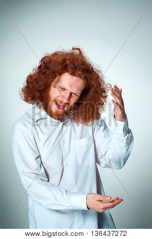 The young vexed man with long red hair