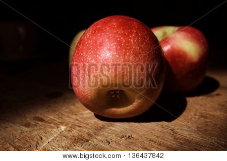 Ripe juicy red and yellow apples on wooden deck
