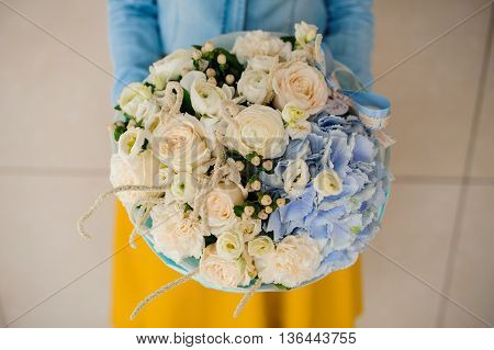 girl holding Bouquet of white and blue flowers