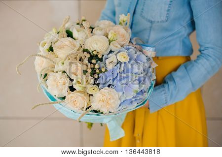 girl holding Bouquet of white and blue flowers