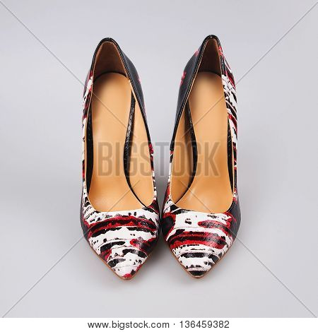 Female high heeled shoes in grey background