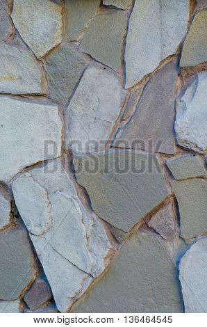 Background of a stone wall cladding texture brown stone bricks