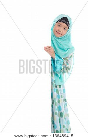 Portrait of asian muslim girl with an empty banner on white background isolated