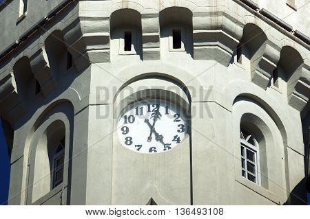 The dial on the tower, showing the five o'clock