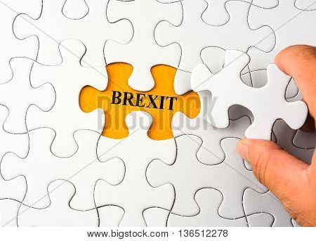 White puzzle on orange background with word brexit
