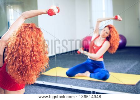 fitness sport training and people concept - smiling woman doing exercises on mat in gym