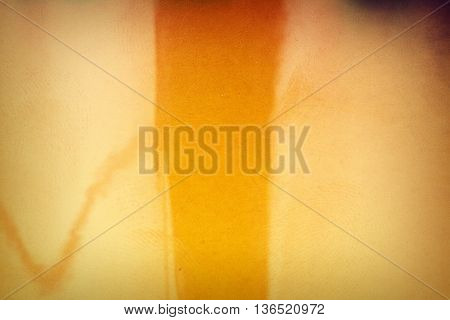 Blank yellow vibrant noisy film strip texture background with fingerprints