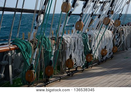 Rigging of a sailing ship, green and white ropes, blocks