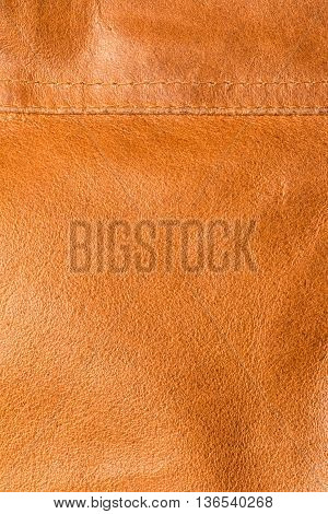 texture of orange - brown hide with seam