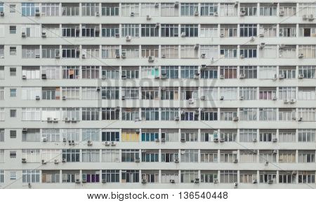 Grey modern apartment building numerous windows shut